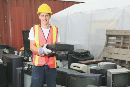 Workers handling builders waste clearance